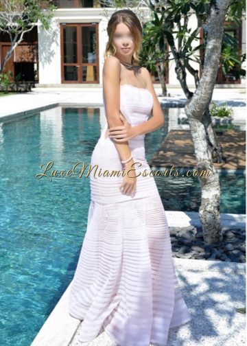 Luxe Miami Escort girl Renata posing in her sexy white dress by the swimming pool