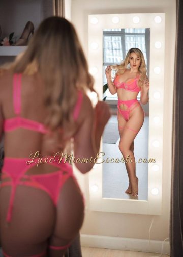 Natasha looking at herself in the mirror, while wearing sexy pink lingerie