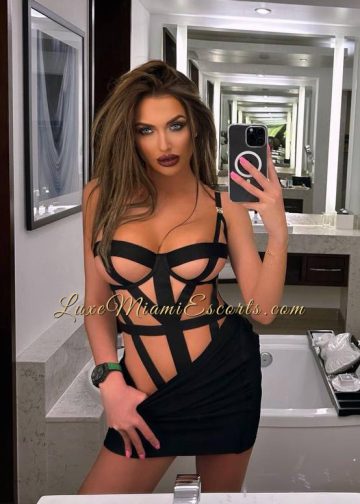 Selfie of glamorous Miami escorts girl Regina. Photo taken in a mirror where Regina is wearing sexy black lingerie