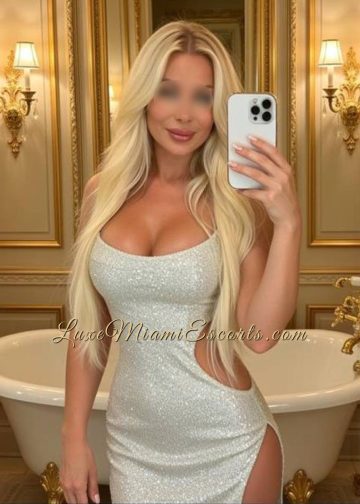 Selfie of gorgeous Miami blonde escort model Lola, wearing sexy silver dress