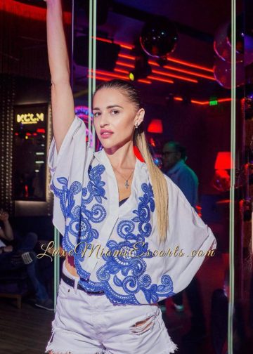 Amateur photo of Mila, posing in sexy denim shorts and blue / white top