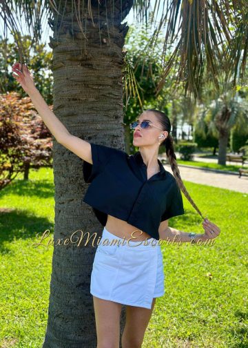 Sexy Miami escort Mila posing outdoor in shot white skirt and black top