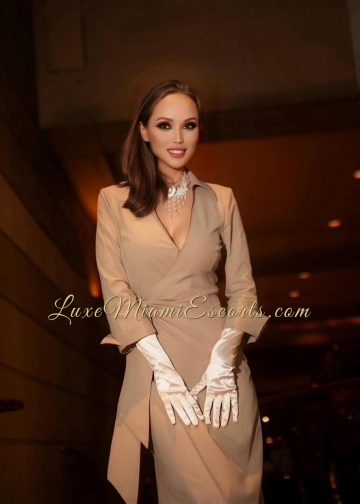 Diane wearing elegant beige dress and white gloves