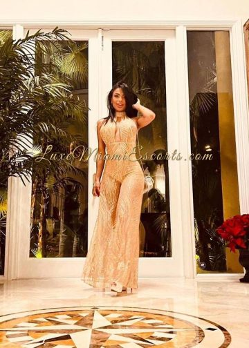 Miranda posing in sexy beige dress