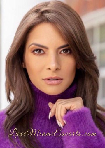 Close up face photo of Miami model Nikita, wearing purple sweater