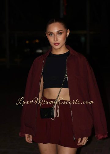 Miami escorts model Kathy wearing short burgundy skirt and jacket