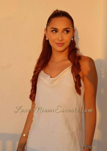 Kathy posing in white outfit.