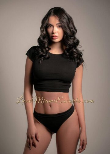 Miami escorts model Angelina posing on professional photos, wearing black top and panties