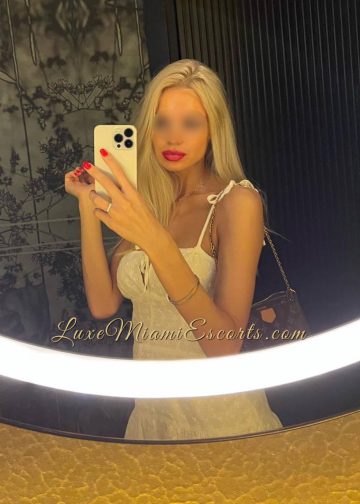 Selfie of super hot escort girl Melissa, wearing sexy white dress