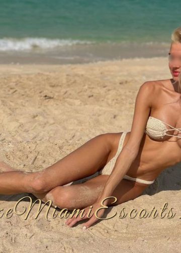 Super hot blonde model Melissa posing on a beach in her sexy white swimwear