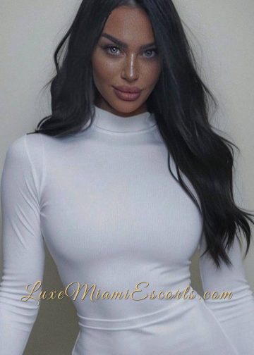 Beautiful Miami escort model posing in white blouse