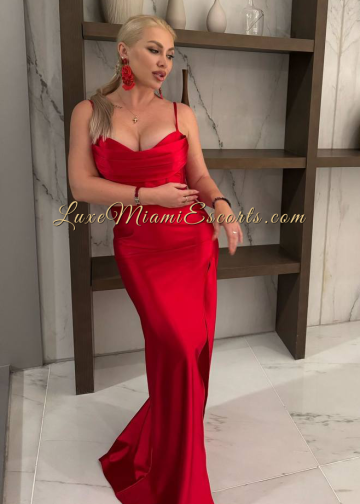 Gorgeous Miami blonde escort girl Oksana posing in sexy red dress