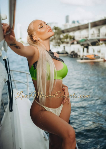 Miami blonde escort Oksana posing on a yacht in her sexy swimwear