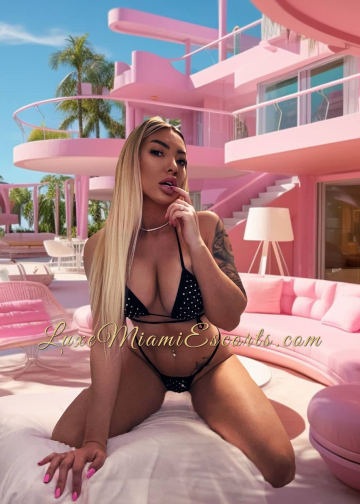 Amateur photo of Adita, posing outdoors in swimwear with pink building on a background