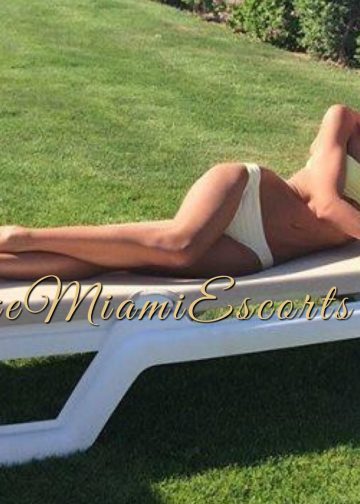 Amateur photo of blonde escort Isabella laying on a pool chair in Miami