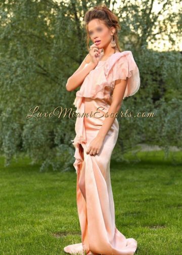 Stunning petite Miami brunette escort model Sofia posing I her beautiful pink evening dress